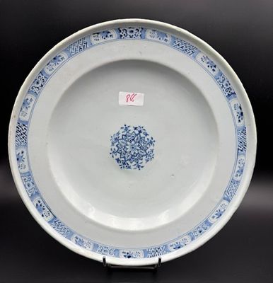 blue and white plate with a floral design on the rim