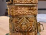 a close up of a vase on a table