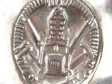 a silver plate with a silver coin on it