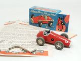 a red toy car and a box of papers on a table