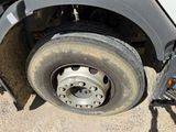 a flat tire on a flatbed truck parked on the side of the road