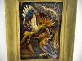 painting of a bird in flight in a gold frame on a white wall