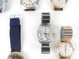 several different types of watches are displayed on a white surface