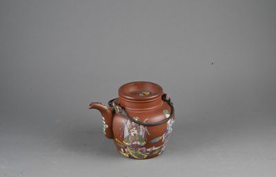 an image of a brown teapot with a handle on a gray surface