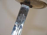 a knife that is stuck in a sink with water coming out of it