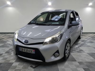 the toyota yaris is parked in the garage with a checkered floor