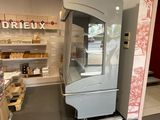 an image of a store with a refrigerator in the middle of the room