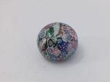 a close up of a glass bead on a white surface