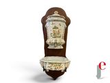a wooden chair with a vase on the back of it
