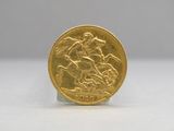 a close up of a gold coin on a white surface