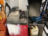 a pile of oil cans and other items in a garage