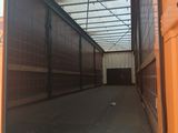 a large orange truck that is parked inside of a building