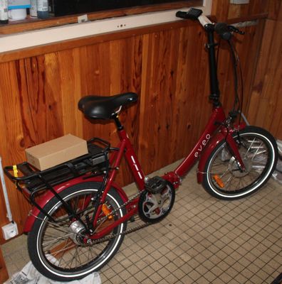 a red bike with a box on the back of it
