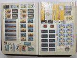 an open book with stamps on it on a table