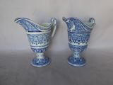 two blue and white vases sitting next to each other
