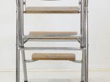 an image of a stack of four chairs with a wooden seat