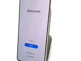 the back of a phone with a welcome button on the screen
