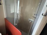 a bathroom with a toilet, sink, and shower in it