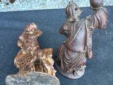 two figurines of a man and a woman sitting on a bench