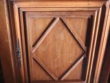 a wooden cabinet with a mirror on top of it