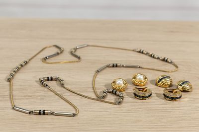 a necklace, earring, and bracelet set on a table