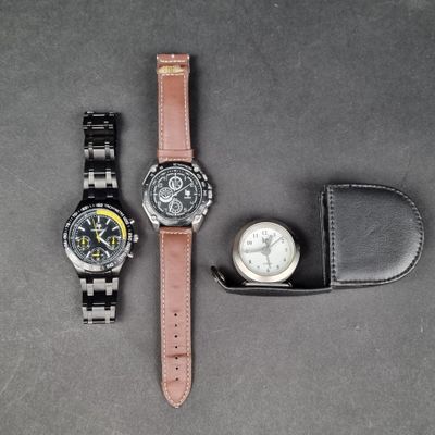 two watches sitting next to each other on a table