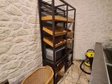 a kitchen with a sink and a shelf with shelves