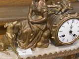 a statue of a woman sitting on top of a clock