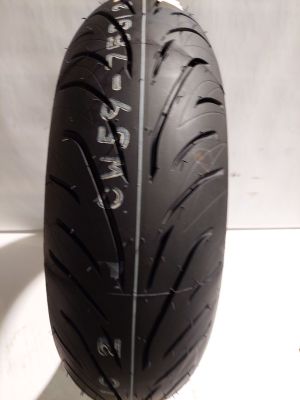 a close up of a motorcycle tire on a white surface