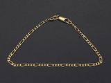 a gold chain bracelet on a black background