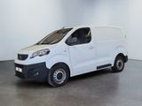 the small white van is parked in a large room