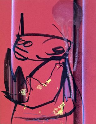a sticker on the side of a red wall with a drawing of a cat