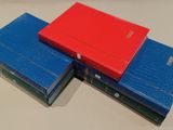 three books are stacked on top of each other on a table