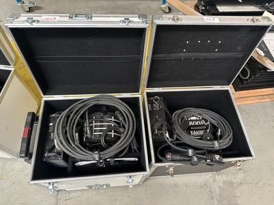 two open cases with cables in them on the floor