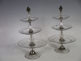 three tiered glass plates with a bird on them
