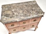a marble top chest of drawers sitting on a table