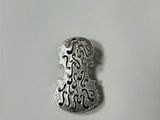 a close up of a metal object on a white surface