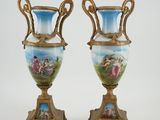 pair of blue and gold vases with flowers and birds painted on them