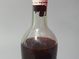 a bottle of wine sitting on a table with a cork stopper