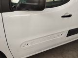 the side view of a white van parked in a garage