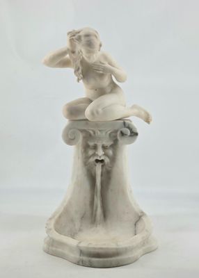 statue of a woman sitting on top of a fountain on a white background