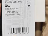someone is holding a tag with a bar code on it
