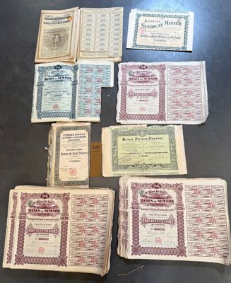 several old certificates are laid out on a table