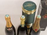 three bottles of champagne sitting next to each other on a table
