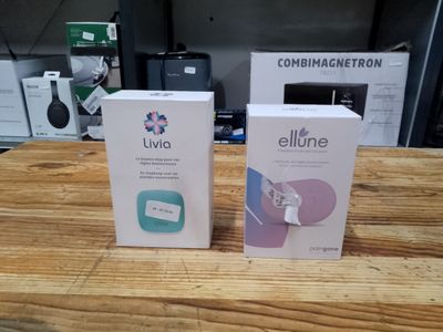 two boxes of electronic devices sitting on top of a wooden table