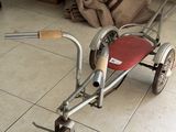 a small child ' s tricycle that is sitting on the floor