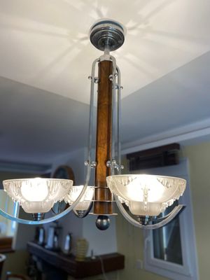 a chandelier with three lights hanging from the ceiling