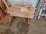 a pile of wood sitting on the floor next to a ladder