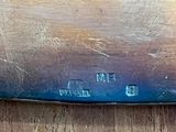 a knife that is sitting on a wooden table