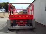 a picture of a red scissor parked in front of a building